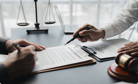 A lawyer and a client signing a contract, symbolizing a legal agreement - Vision Law®