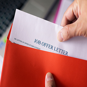 Job offer letter in a red envelope; legal advice for California employers to prevent wage claims.